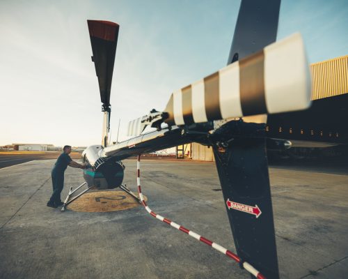 male-pilot-inspecting-helicopter-PZLZPES.jpg